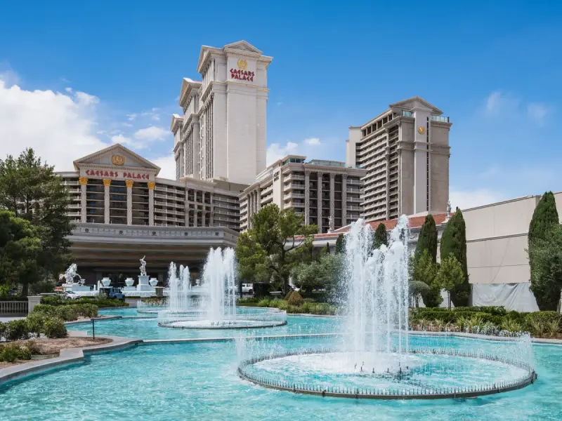 Caesars Palace towers behind the fountains and gardens along Las Vegas Boulevard