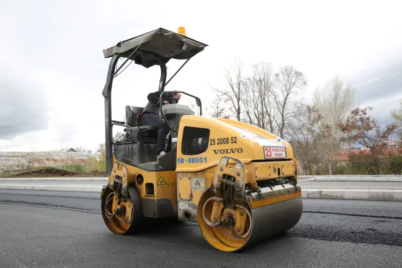 Road roller compacting a fresh layer of asphalt