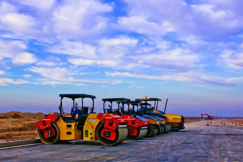 Road rollers parked on a construction site in daylight
