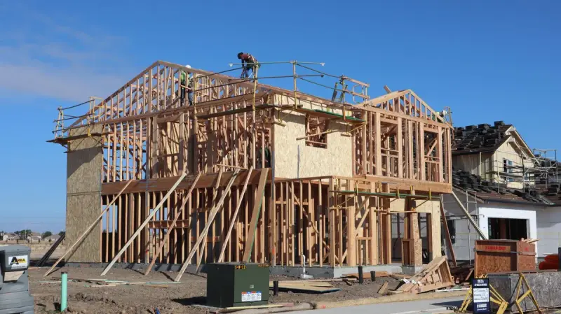 Wood framing of a new house under a clear blue sky in Sacramento