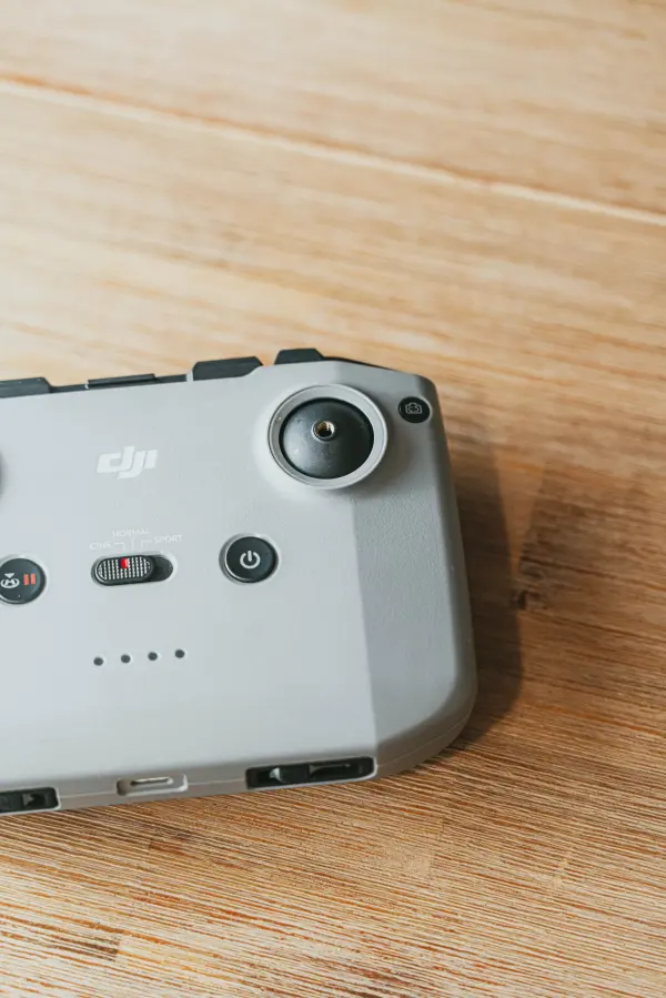Drone controller resting on a wooden tabletop