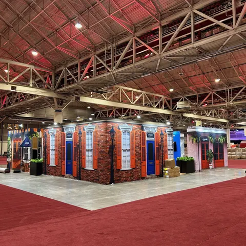 Amazon booth by Purple Exhibits: wide view of a large walk-through environment styled as a New Orleans French Quarter