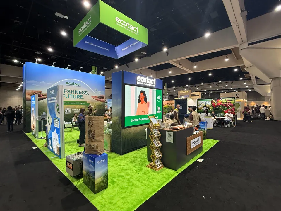 Ecotact booth by Purple Exhibits: wide view of the Ecotact island booth with green turf flooring