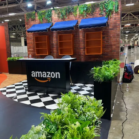 Amazon booth by Purple Exhibits: close-up of the Amazon storefront-style reception counter in a black finish