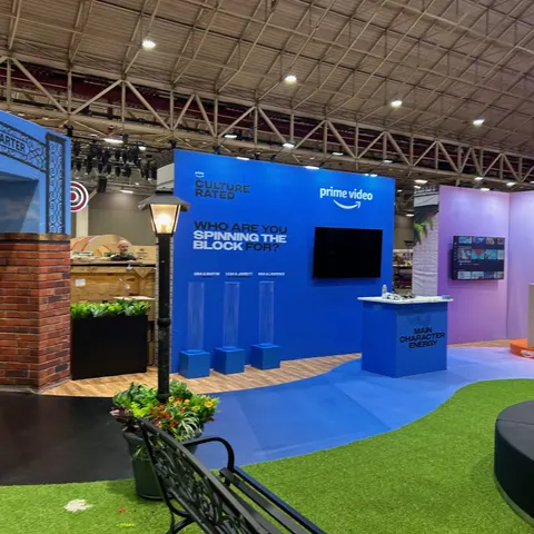 Amazon Prime Video booth by Purple Exhibits: bright blue Prime Video Culture Rated wall with a large screen