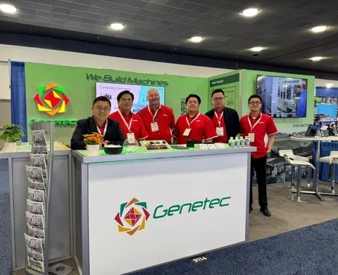 Genetec booth by Purple Exhibits: genetec inline booth with a green We Build Machines back wall, a white counter