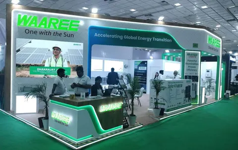 Waaree booth by Purple Exhibits: green and white Waaree solar booth