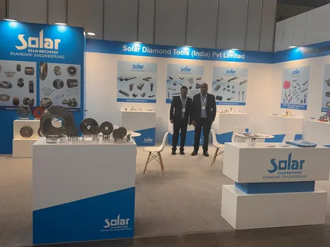 Solar Diamond Tools (India) Pvt Limited trade show booth built by Purple Exhibits: Blue and white inline booth for Solar Diamond Tools with diamond grinding wheels and tools on white plinths, printed product graphics, ch