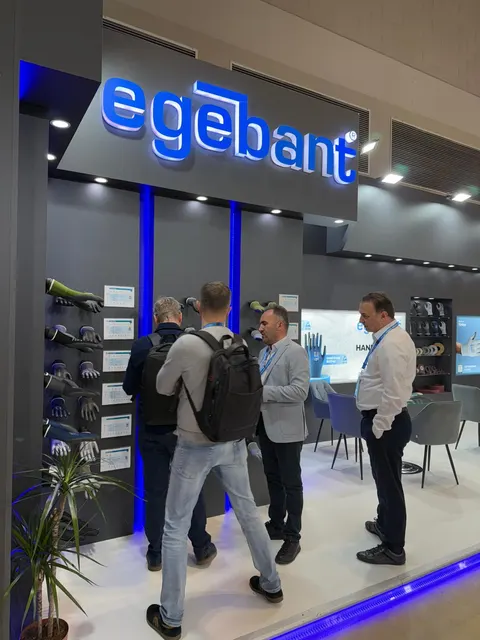 egebant booth by Purple Exhibits: dark grey booth with a large illuminated egebant logo and blue LED accents