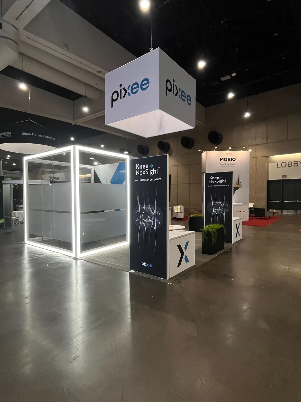Pixee booth by Purple Exhibits: pixee island booth with a white cube hanging sign
