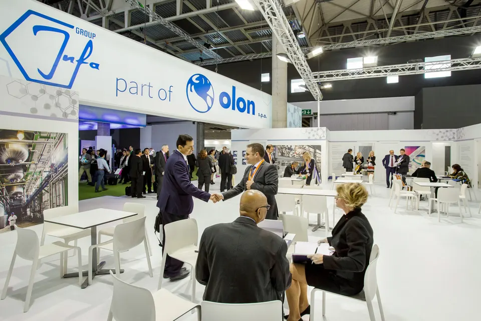 Olon / Infa Group booth by Purple Exhibits: white Olon 'part of Infa Group' booth with blue branding