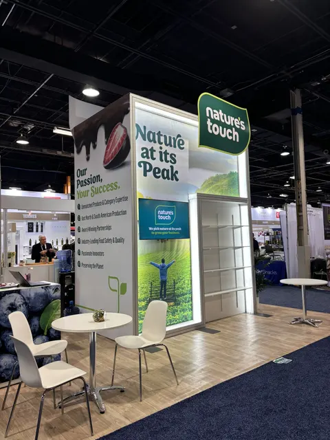 Nature's Touch booth by Purple Exhibits: rear side of the Nature's Touch tower with 'Nature at its Peak' backlit graphic