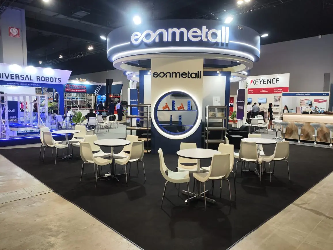 Eonmetall booth by Purple Exhibits: navy-and-white island booth for Eonmetall with a large illuminated circular header, shown for IWF West exhibitors