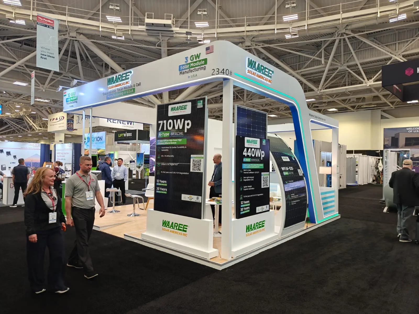 Waaree booth by Purple Exhibits: corner angle of the Waaree solar island booth showing 710Wp, an example for ACP OMS exhibitors in Long Beach
