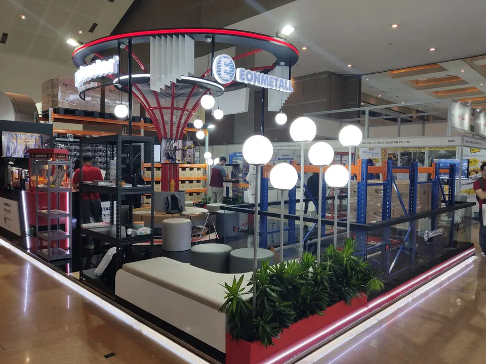 Eonmetall booth by Purple Exhibits: eonmetall island booth with a circular red and black overhead ring, the kind of booth we build for Automation Fair