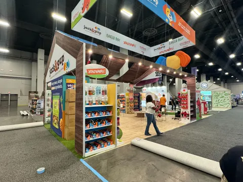 Jack & Pup booth by Purple Exhibits: wide view of the Jack & Pup pet-treat booth with a peaked wood-clad gable