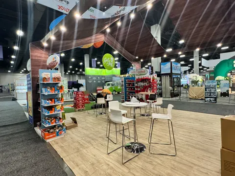 Jack & Pup booth by Purple Exhibits: interior of the Jack & Pup island showing wood-slat canopy ceiling, Purple work to compare for your AGTA GemFair Tucson booth