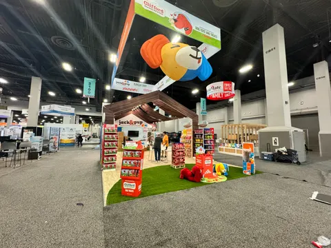 Jack & Pup booth by Purple Exhibits: wide view of the Jack & Pup island with a giant inflatable dog head