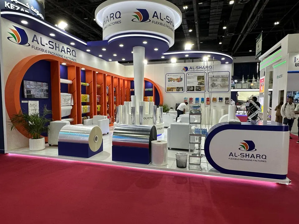 Al Sharq booth by Purple Exhibits: al Sharq island booth with a circular header sign on a central column