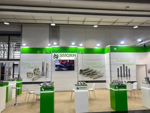 SMOXH booth by Purple Exhibits: frontal view of the SMOXH Cutting Tools booth with green header, white walls