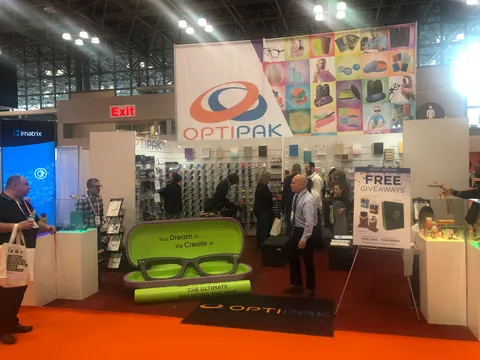 Optipak booth by Purple Exhibits: optipak eyewear-case booth with a tall hanging banner, colourful product wall