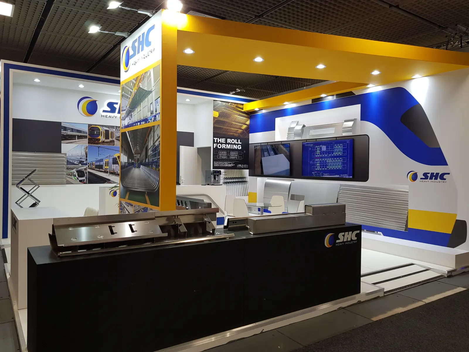 SHC Heavy Industry booth by Purple Exhibits: sHC Heavy Industry booth in white, yellow and navy, shown for MT Series WEST exhibitors