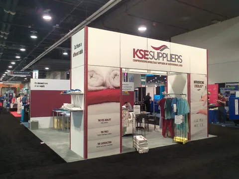 KSE Suppliers booth by Purple Exhibits: exterior corner view of a white KSE Suppliers booth with tall header