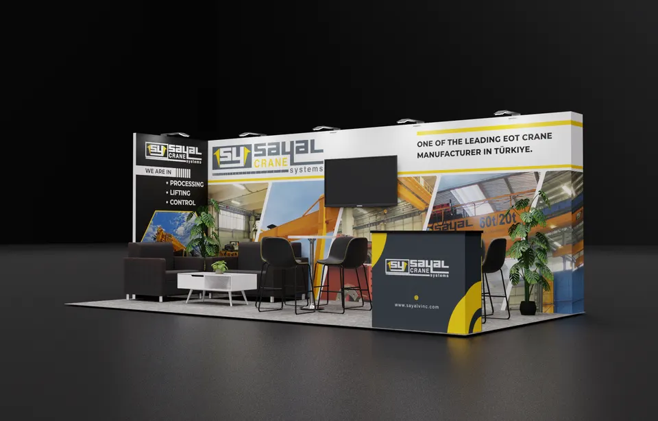 Purple Exhibits booth design concept: Angled 3D render of a 10x20 inline booth for Sayal Crane Systems with yellow, black and white graphics of overhead EOT cranes, a wall-mounted TV, a black lounge sofa set, a bar table with stools, a branded counter and a potted plant on grey carpet.
