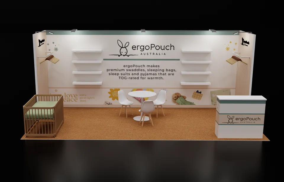 Purple Exhibits booth design concept: 3D render of a soft cream and sage 10x20 inline booth for ergoPouch Australia baby sleepwear with wall shelves, a wooden crib display, a round table with white chairs and a branded counter on natural flooring.