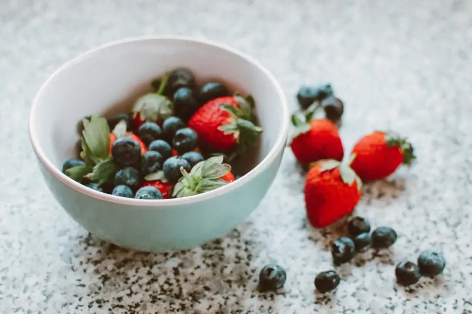 Strawberries and blueberries in a blue bowl