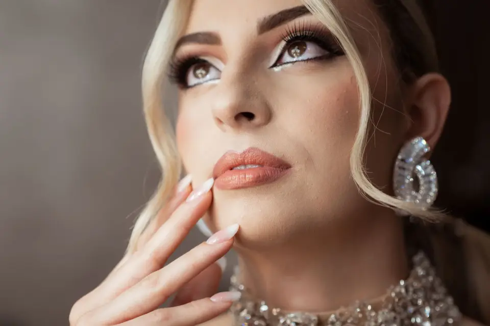Woman with crystal statement earrings and a diamond collar necklace, fashion jewelry portrait