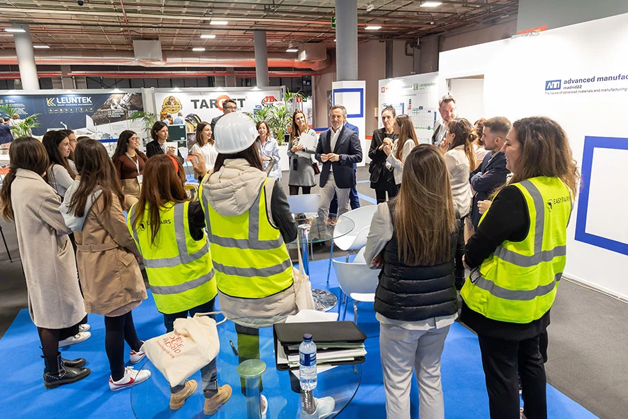 An Easyfairs team briefing on the exhibition floor An Easyfairs event team gathers for a briefing around a table on the exhibition floor.