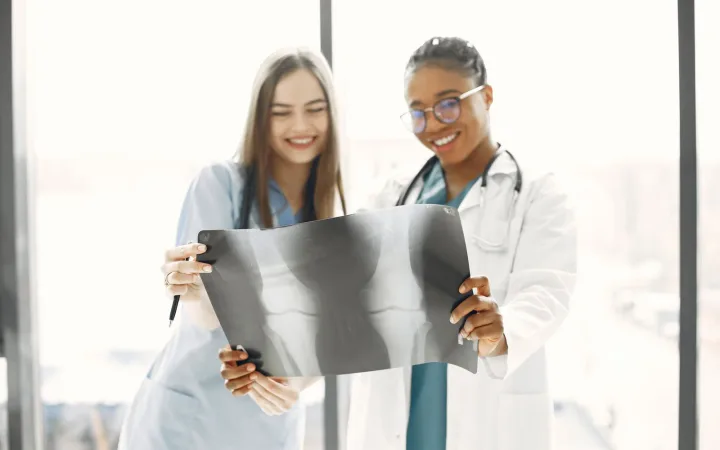 Two women healthcare professionals reviewing an X-ray together