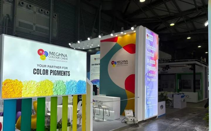 Meghna Colour Chem exhibit with an illuminated color-pigment graphic, vertical colored fins and a tall backlit branding tower.