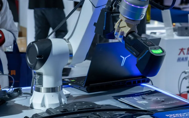Robotic arms and demonstration fixtures displayed at a technology exhibition.