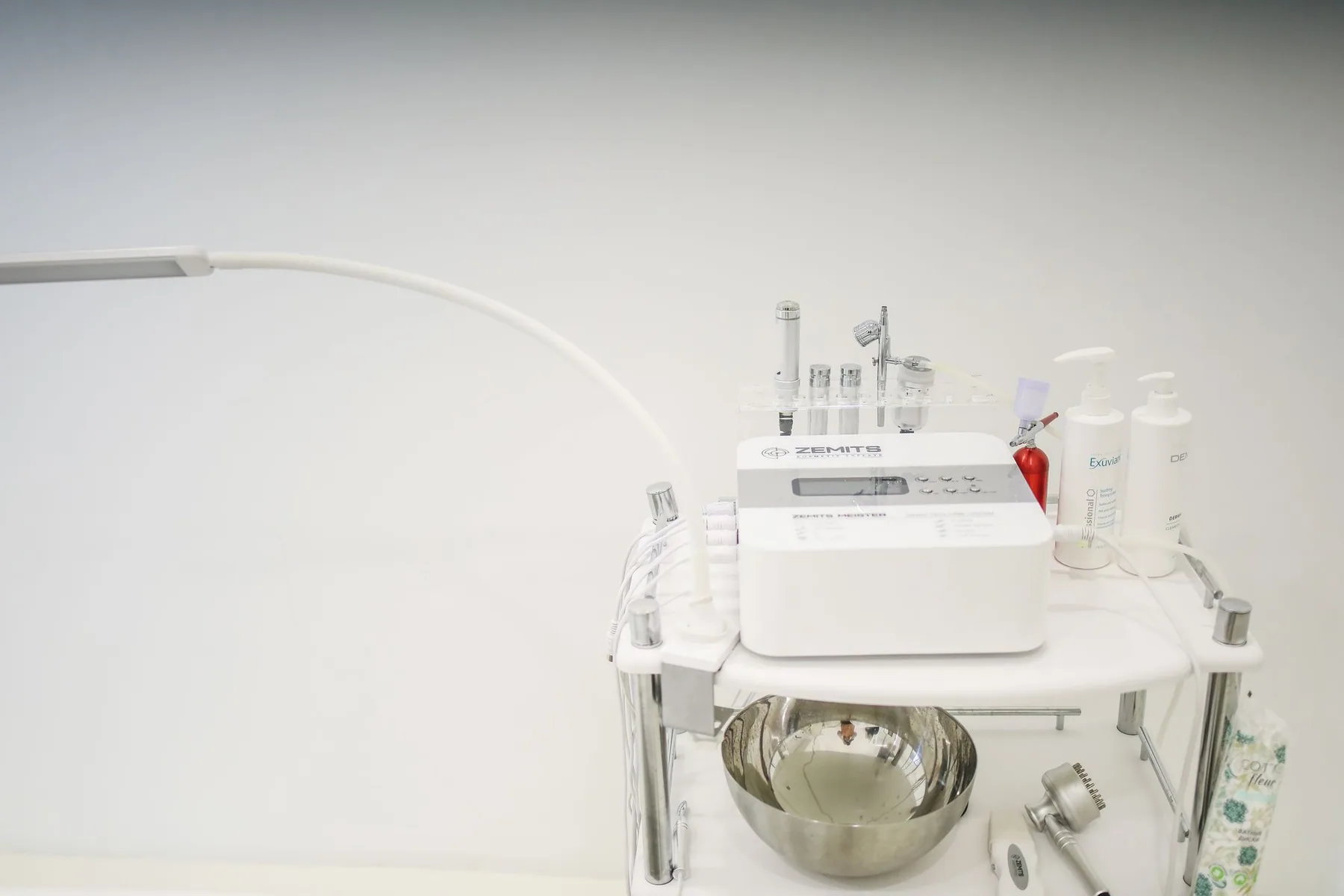 A skincare device and accessories arranged in a beauty treatment setting.