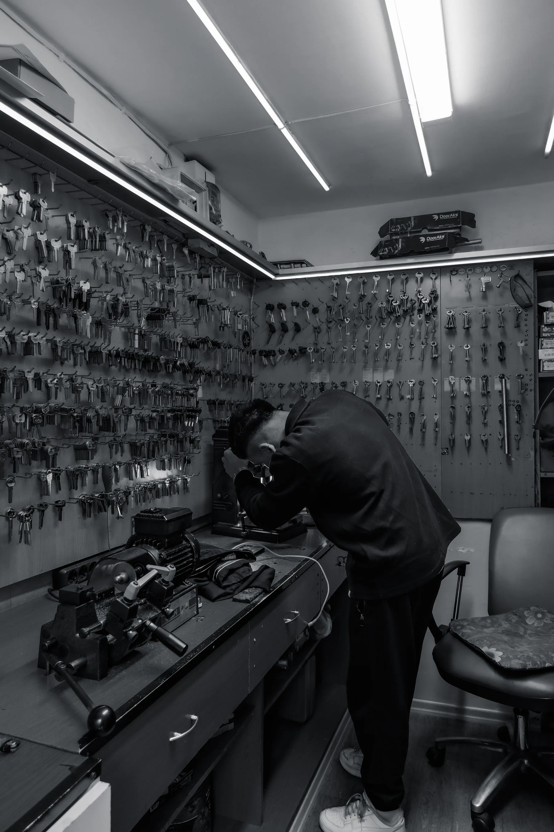 A locksmith works in a shop filled with keys in Istanbul.