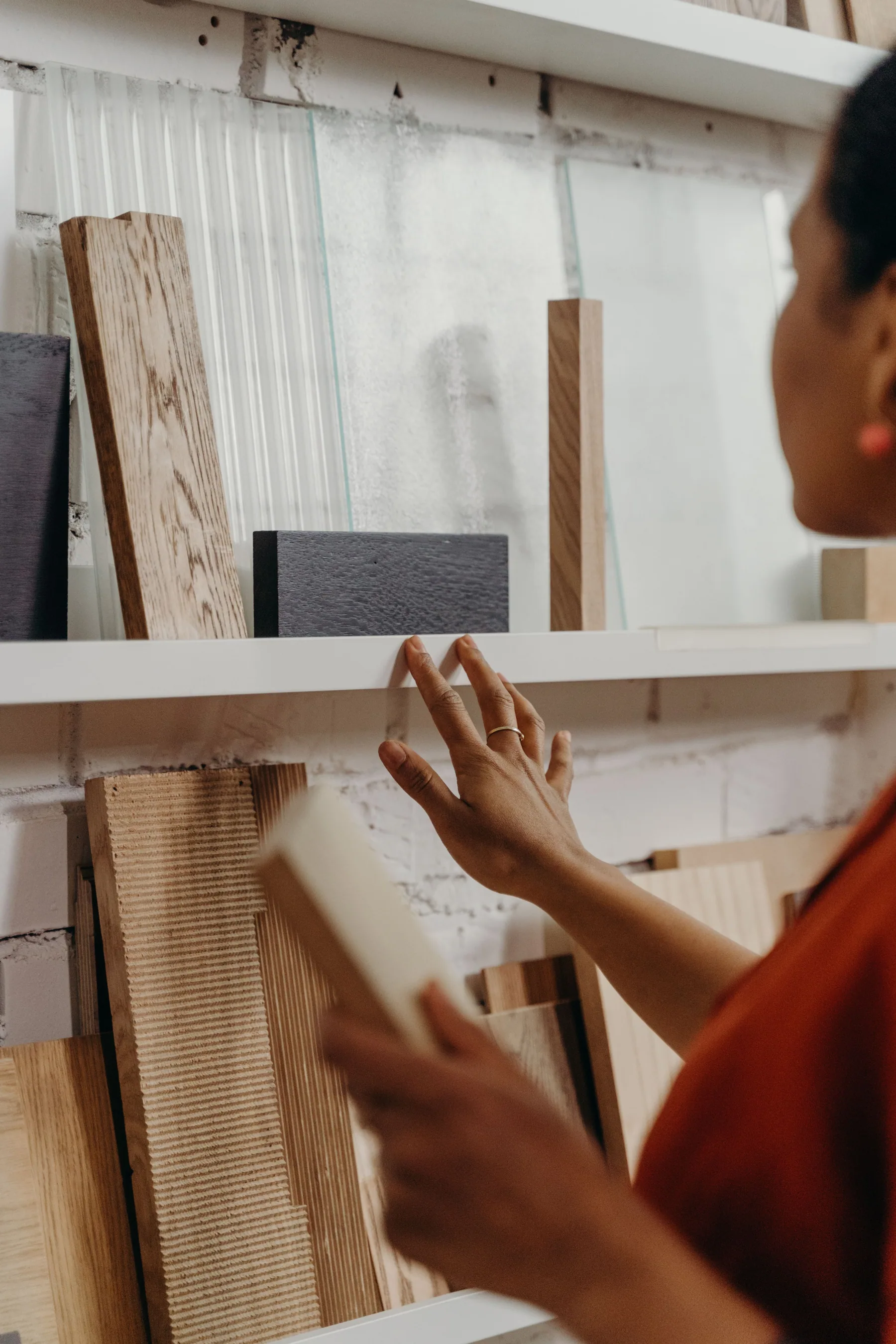 A woman examines a selection of wood samples.