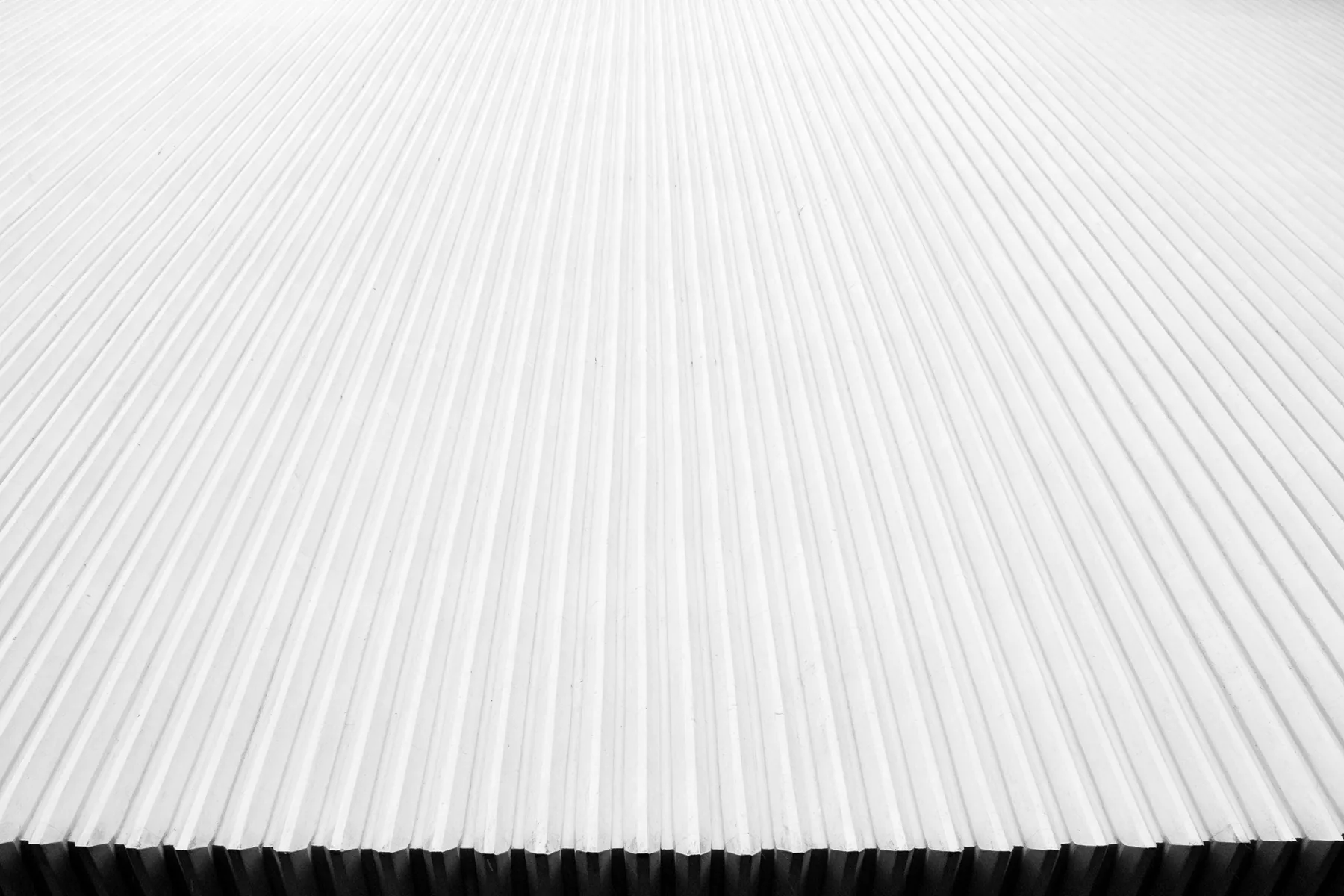 Close detail of white corrugated metal roofing.