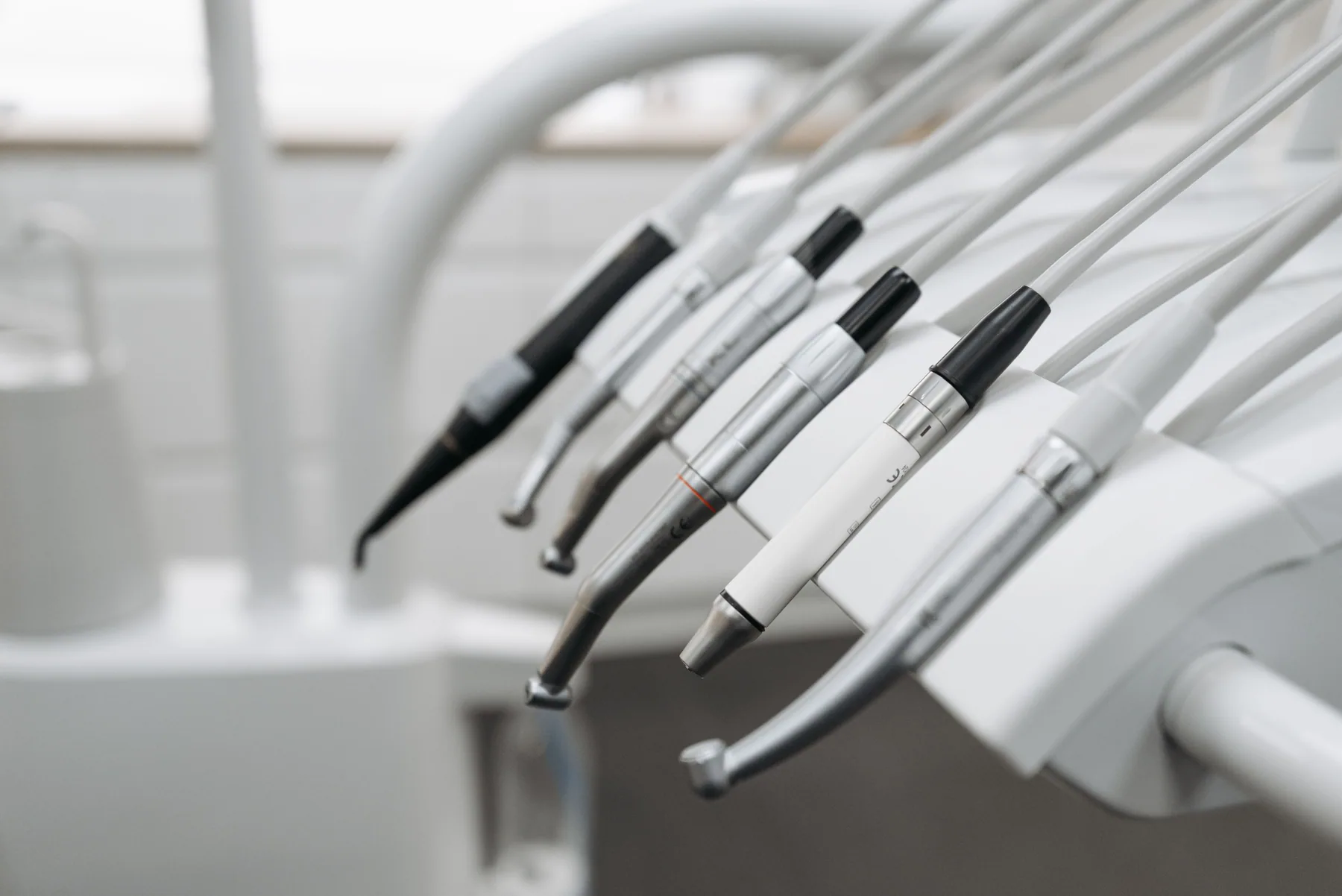 Dental instruments arranged on a holder in a clinic.