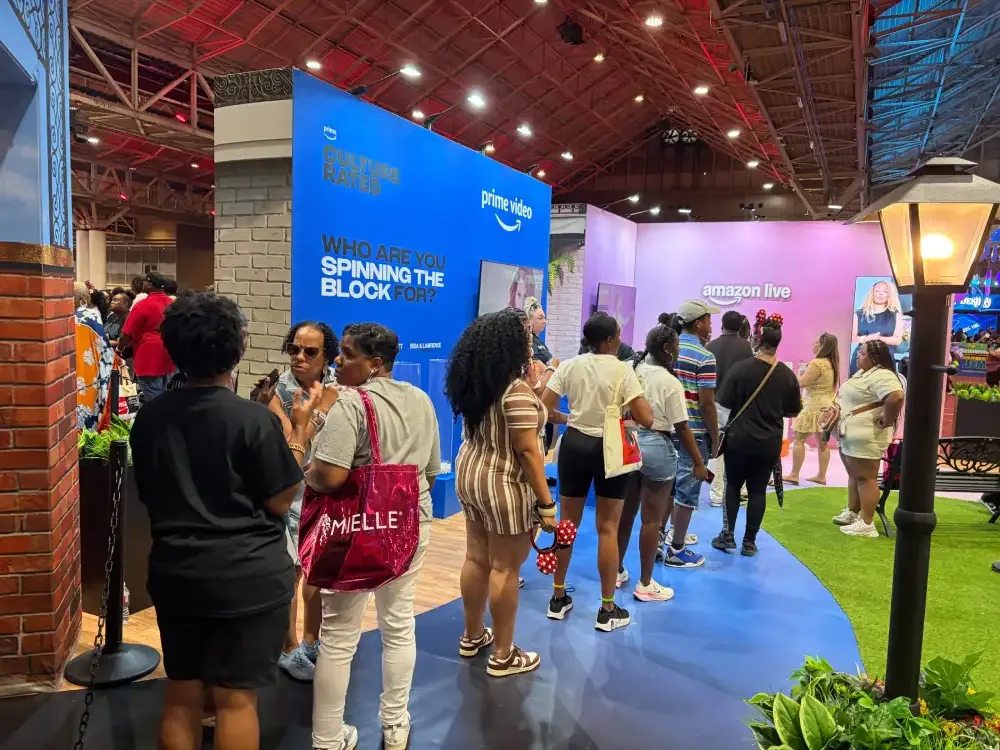 Attendees moving along a blue path between Prime Video and Amazon Live branded screen experiences.