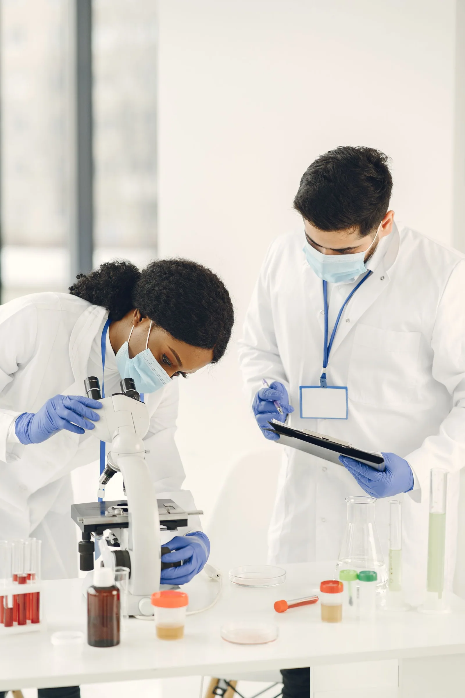 Two researchers collaborating at a microscope