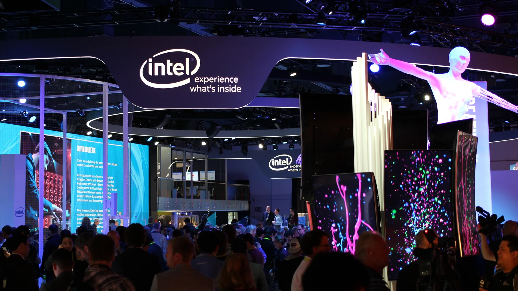 Visitors exploring Intel’s large technology exhibit at CES 2016, with illuminated overhead branding and colorful interactive displays.