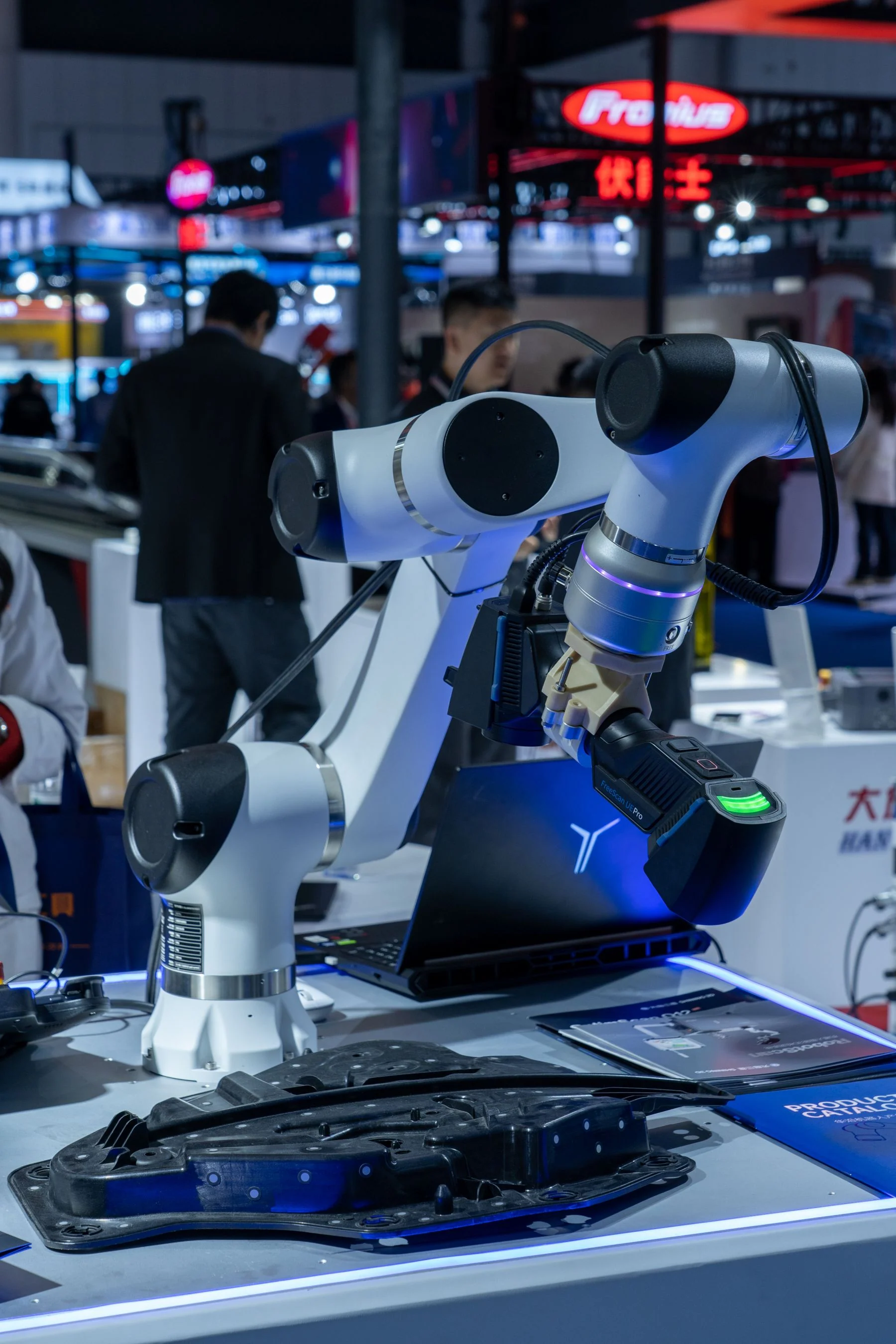 Robotic arms and demonstration fixtures displayed at a technology exhibition.