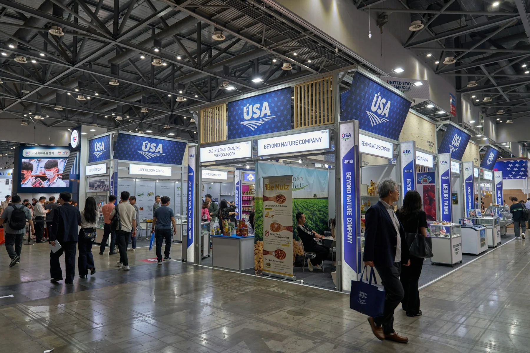 Food industry visitors explore product displays and tasting counters in the USA pavilion at Seoul Food 2025.