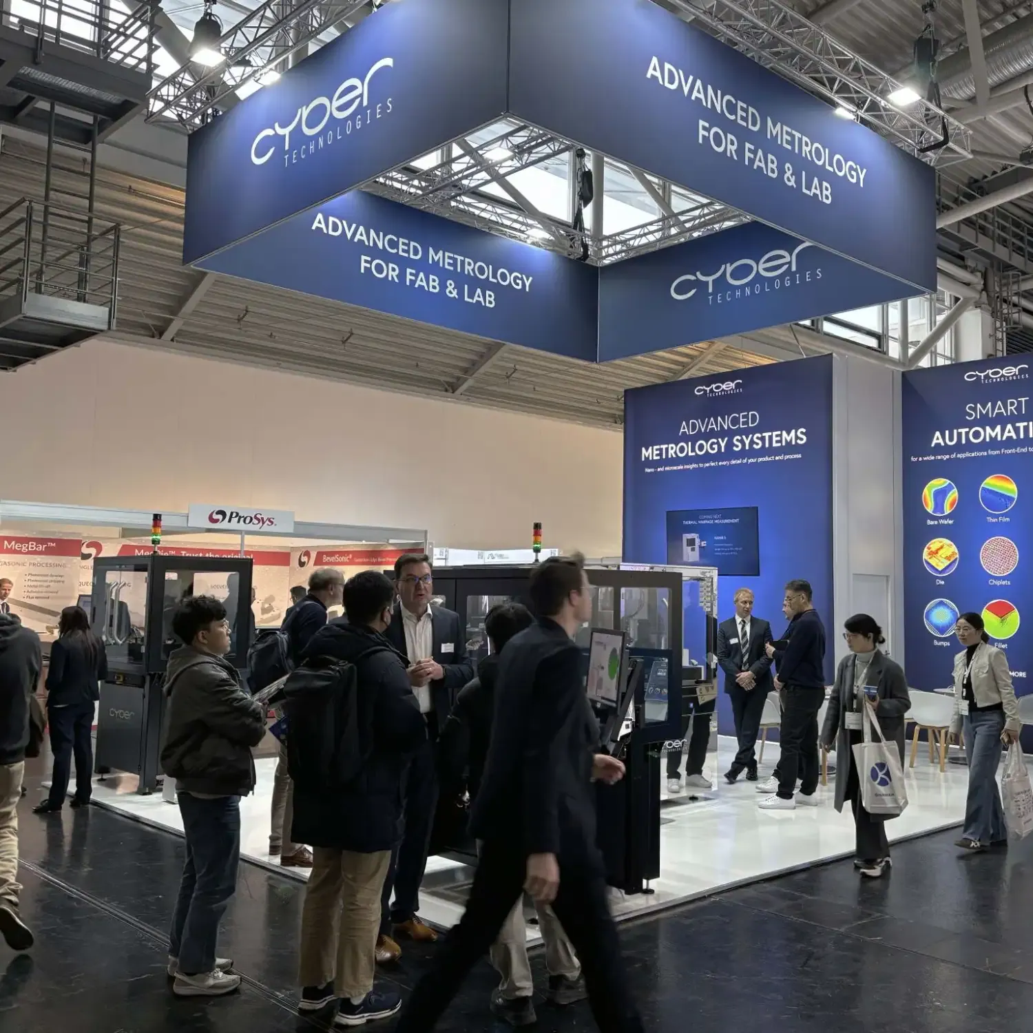 Visitors gathered around metrology equipment beneath cyberTECHNOLOGIES signs reading Advanced Metrology and Smart Automation.