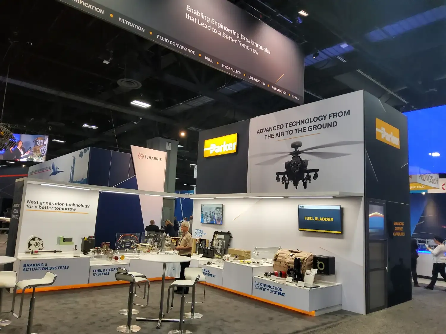 Parker exhibit wall with a helicopter graphic above illuminated displays of actuation, fuel, hydraulic and safety-system components.