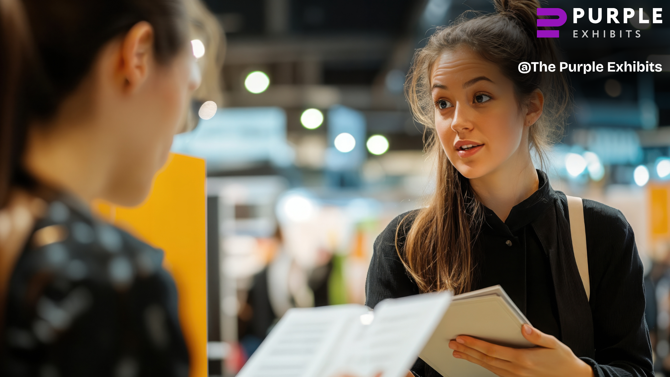 Two attendees discussing materials at a display, demonstrating how Las Vegas Trade Show Booths engage visitors with help from Las Vegas Trade Show Experts.