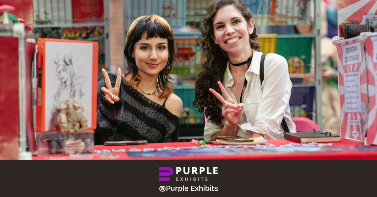Smiling exhibitors interacting at a creative booth setup, reflecting people-focused Custom Exhibits NYC planned through thoughtful NYC Exhibit Design.