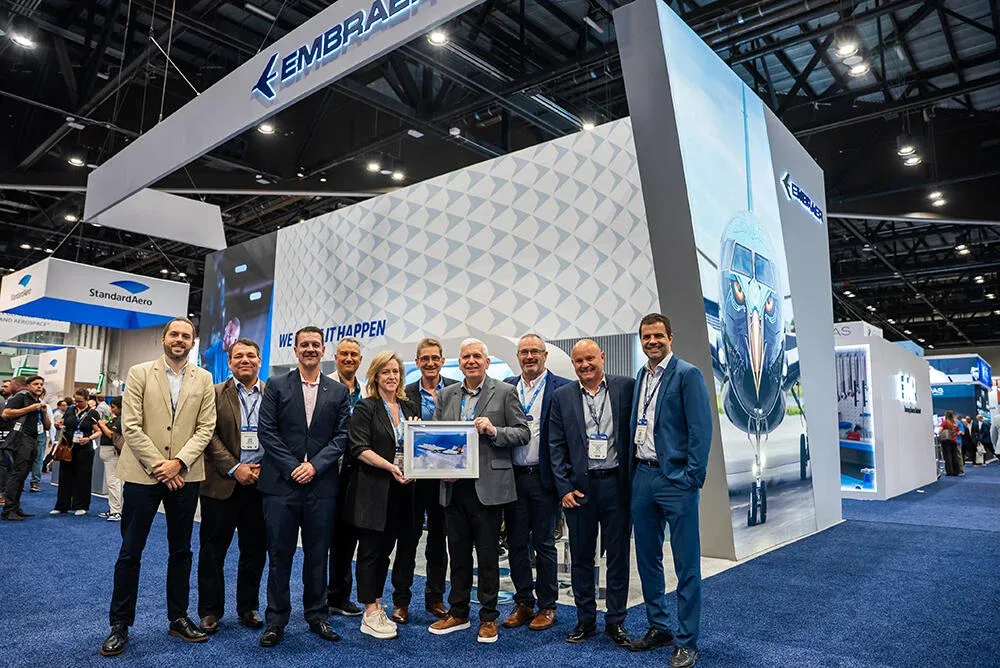 Large Embraer aviation exhibit with digital aircraft graphics and a professional booth team at MRO Americas 2026 in Orlando